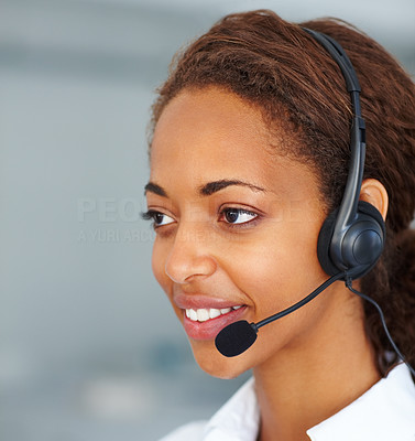 Closeup of beautiful young secretary using a headset