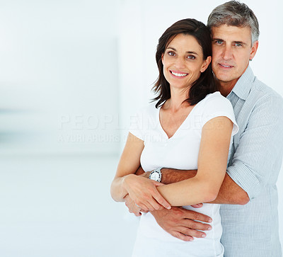 Happy mature man with his arms around his beautiful wife