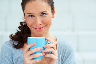 Closeup portrait of happy young female holding a coffee cup