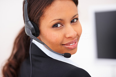 Attractive young woman with headset looking over shoulder