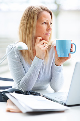 Portrait of mature business woman drinking coffee and looking away