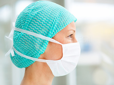 Closeup profile of a female surgeon with a face mask