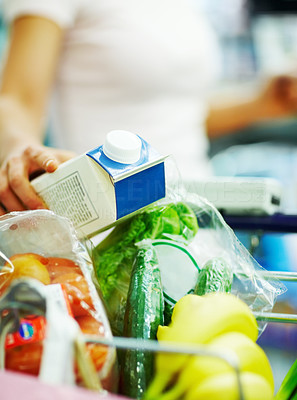Closeup of a grocery items being collected by a woman