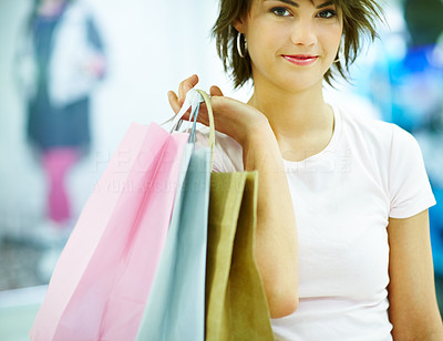 Closeup of a beautiful young woman holding shopping bags