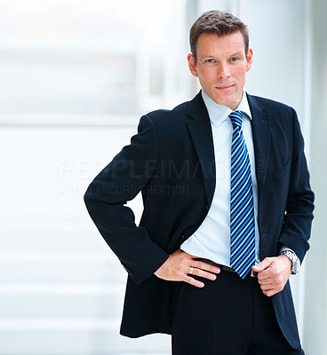 Portrait of smart young businessman standing in black suit