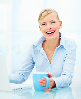 Young business person using laptop holding cup of coffee over white background