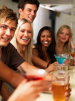 Closeup of joyful young people having drinks