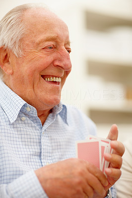 Closeup of senior man shuffling playing cards