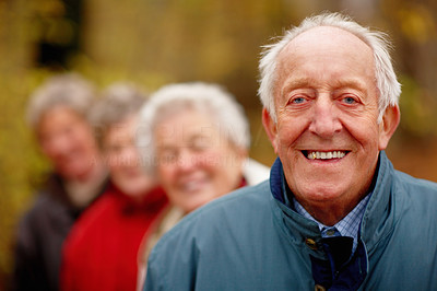 Friendly older man standing in a line