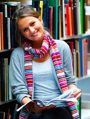 Beautiful lady holding book in library