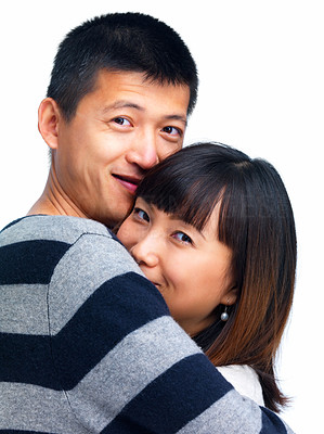 Young asian couple hugging on white