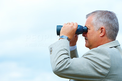 Business vision - Businessman using binoculars
