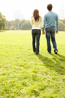 Young couple walking together in a field
