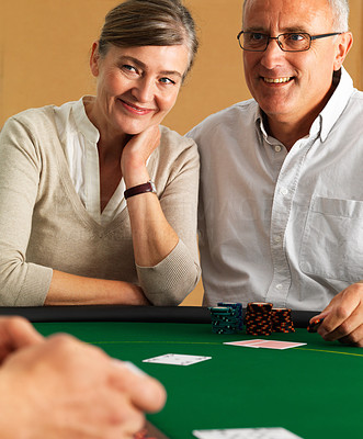 Closeup of mature couple gambling at casino