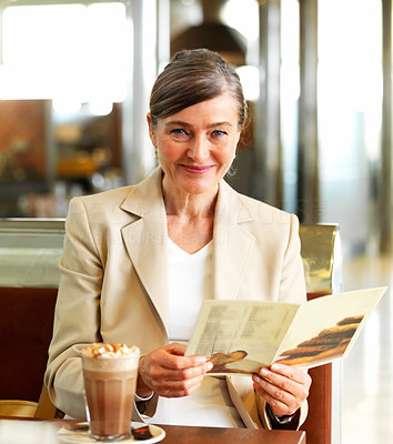 Happy mature woman sitting in a restaurant