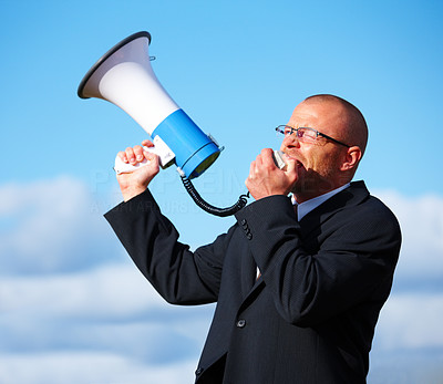 Businessman shouting in a megaphone