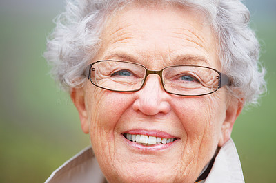Closeup of a happy senior woman wearing glasses and smiling