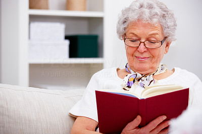 Closeup of an old woman sitting and reading a book