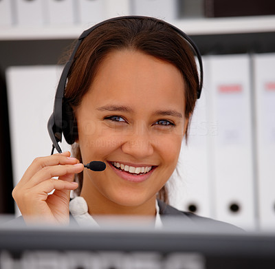 Friendly young office woman using headset