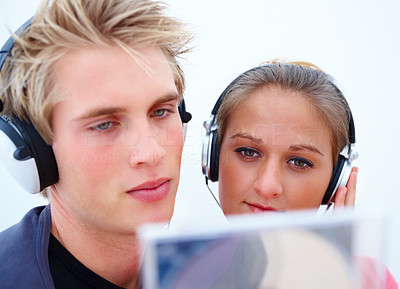 Young couple checking out a new music cd