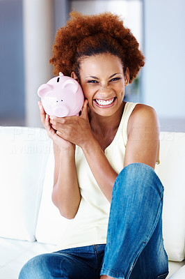 Cheerful woman holding her piggy bank