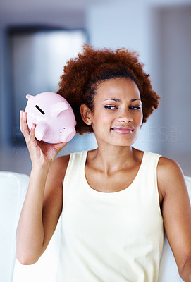 African American woman holding piggy bank