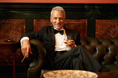 Smiling man with cigar and brandy