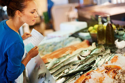 Beautiful woman selecting fish