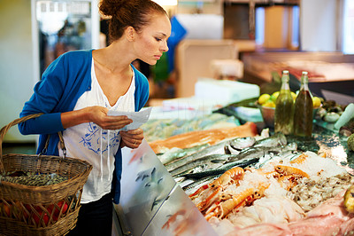Woman looking at a fresh fish display