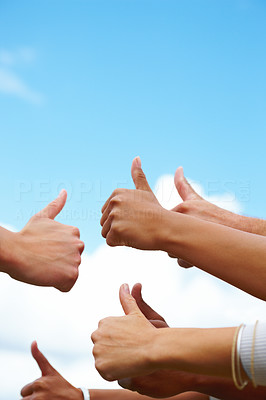 Success - Mixed hands raised to the sky giving thumbs up