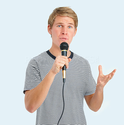 Closeup of a young man singing on microphone