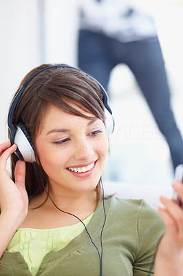 Pretty teenaged female hearing music on mp3
