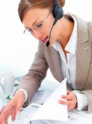 Business lady talking on headset at desk