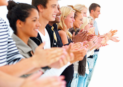 Young men and women standing in a row and clapping hands