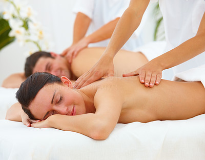 Young man and woman getting back massage at spa