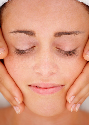 Beautiful young girl receiving face massage
