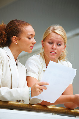 Business women conversing over a document