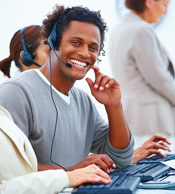 Closeup of a happy male executive with headset using headset