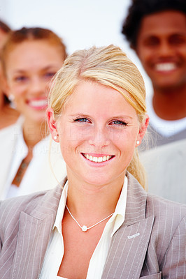 Closeup portrait of a happy business woman with executives against white