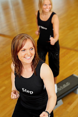 Women stepping in a fitness center