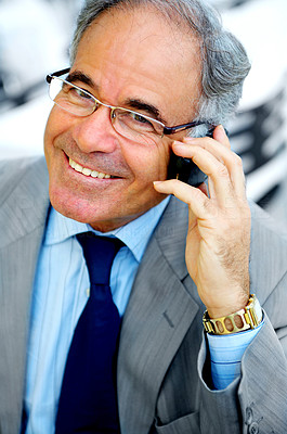 Elderly Businessman on a Break with his cell phone