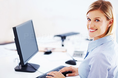 Happy female executive using computer