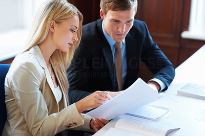 Business people conversing about document
