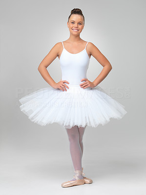 Cute ballerina wearing tutu posing against white background