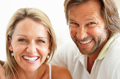Closeup portrait of cute cheerful couple giving you a warm smile