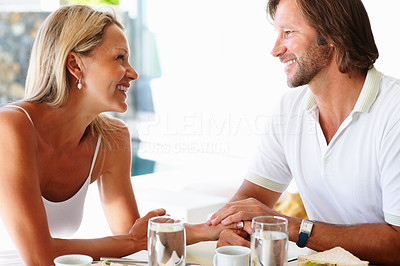 Romantic mature couple looking at each other during breakfast