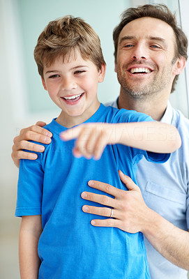 Young boy showing something intersting to his father