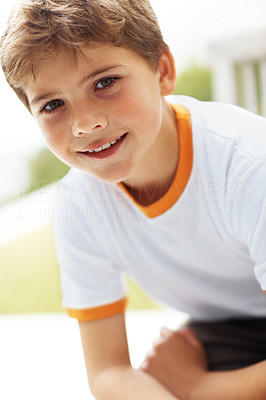 Portrait of a little boy looking happy outside
