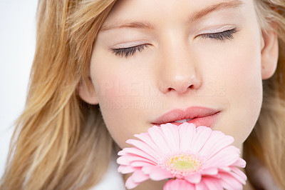 Young girl smelling flower