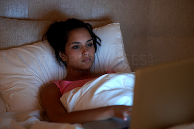 Young Indian woman using laptop at home